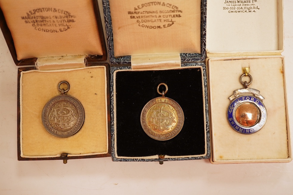 A quantity of assorted silver life-saving and swimming medals, early 20th century, cased